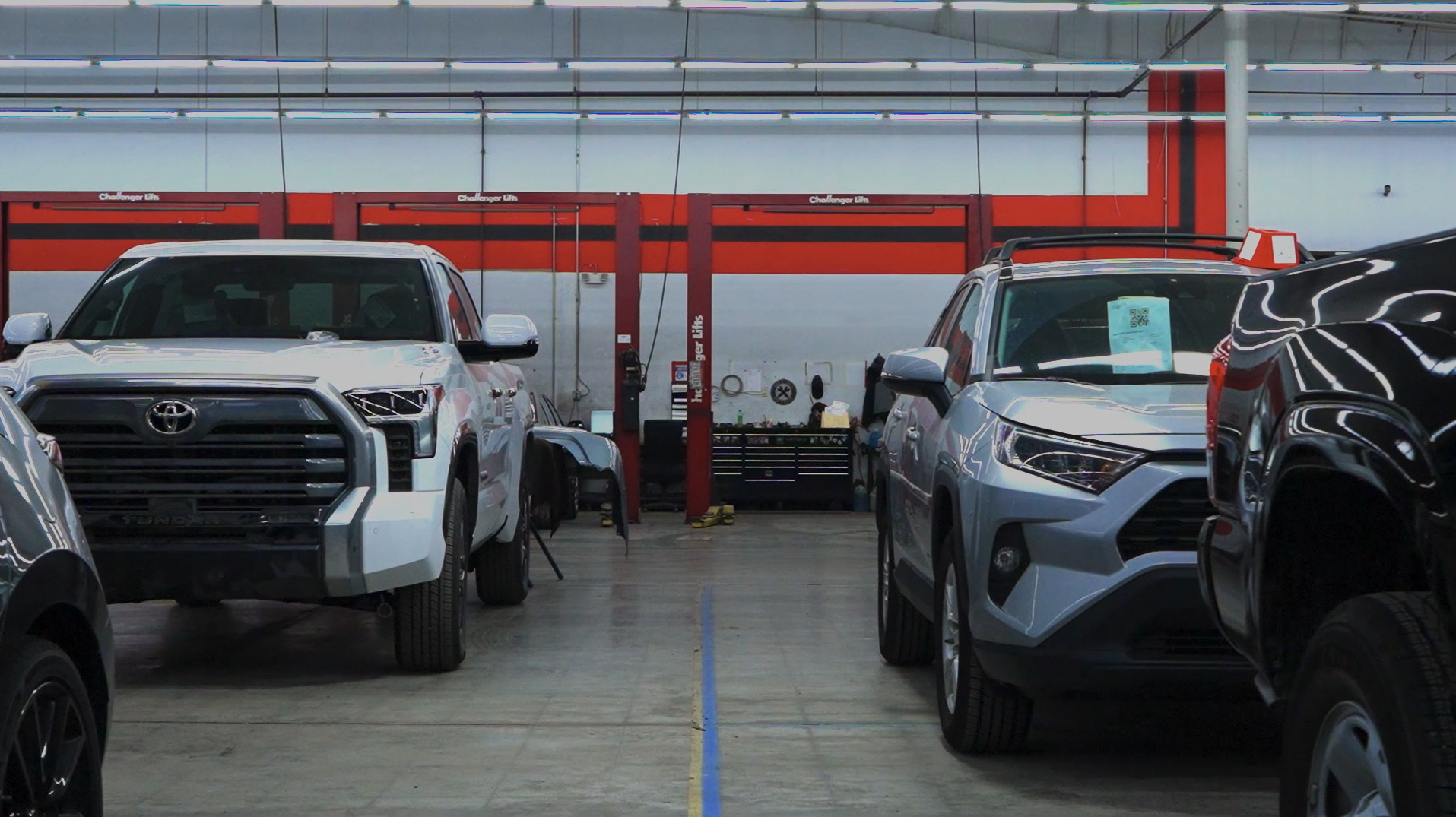 Inside the shop at tansky advanced auto body. Rows of cars.